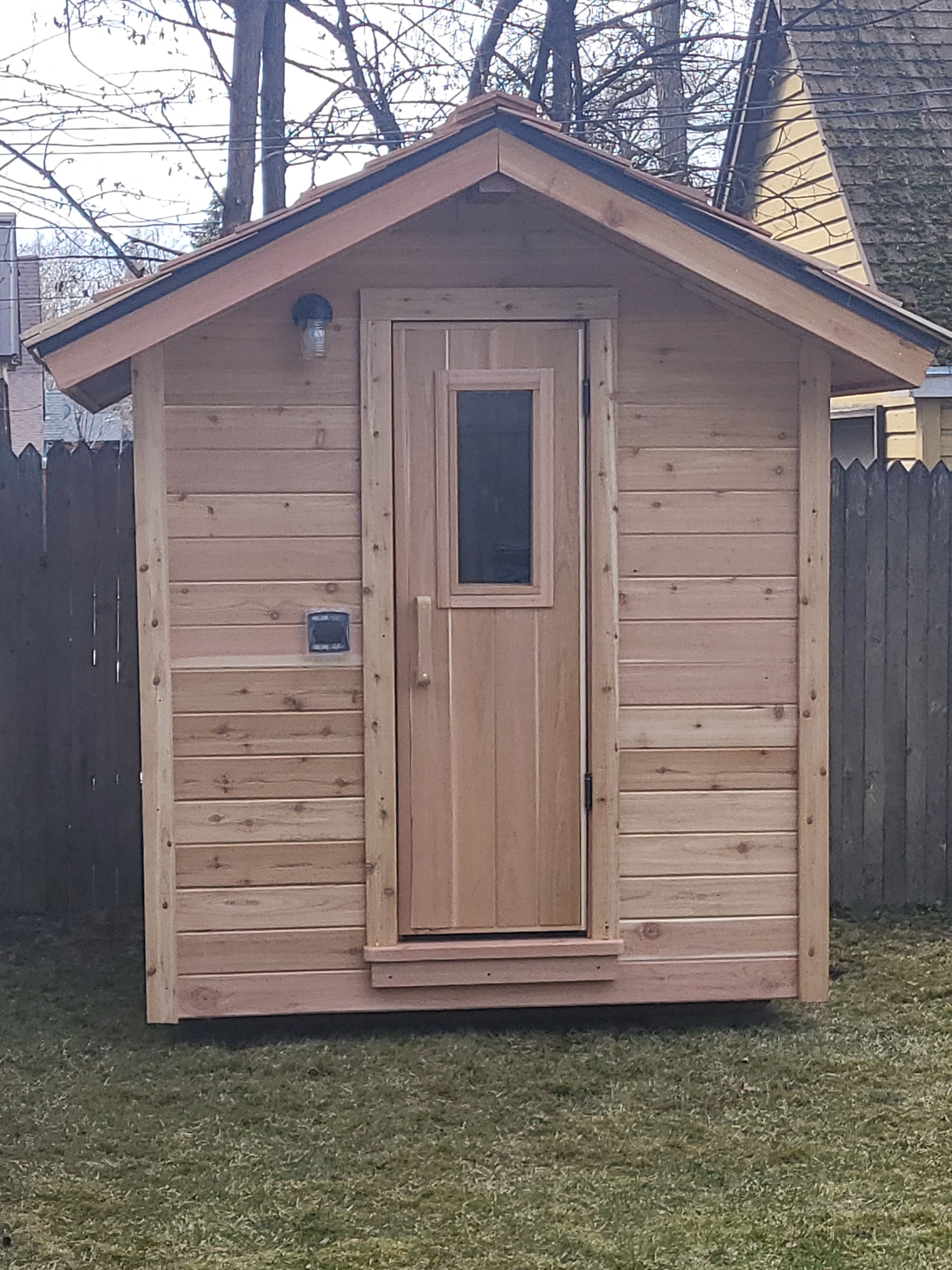 Custom built cedar sauna with cedar shake roof.