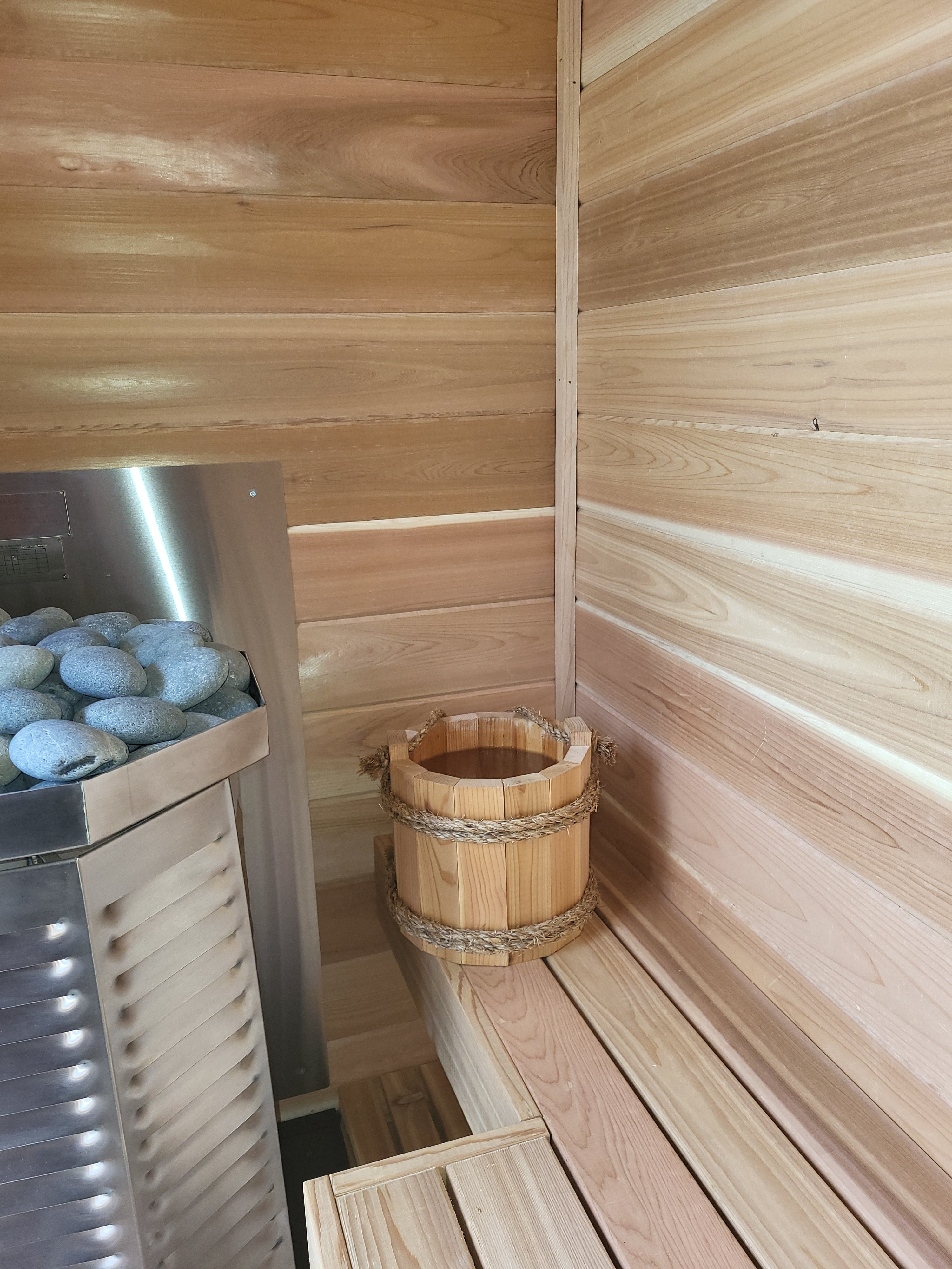 A sauna bucket placed inside a custom built sauna by Sauna Fauna