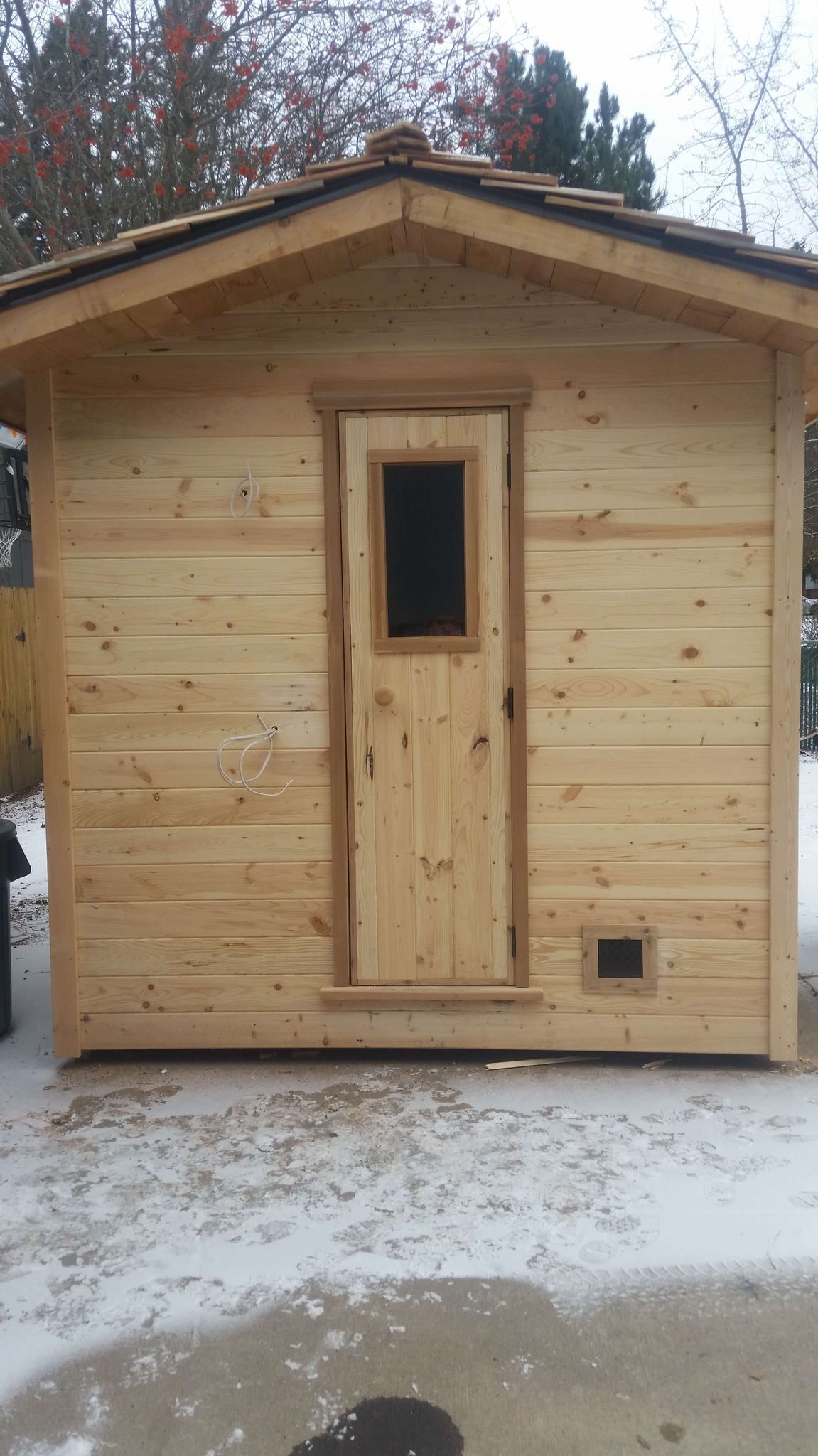 A custom made sauna with cedar shake roof